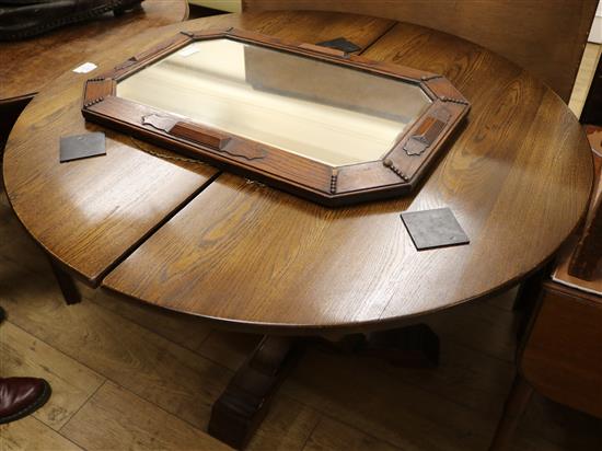 An oak single pedestal extending dining table, and a 1930s oak wall mirror, table W.3ft 10in.